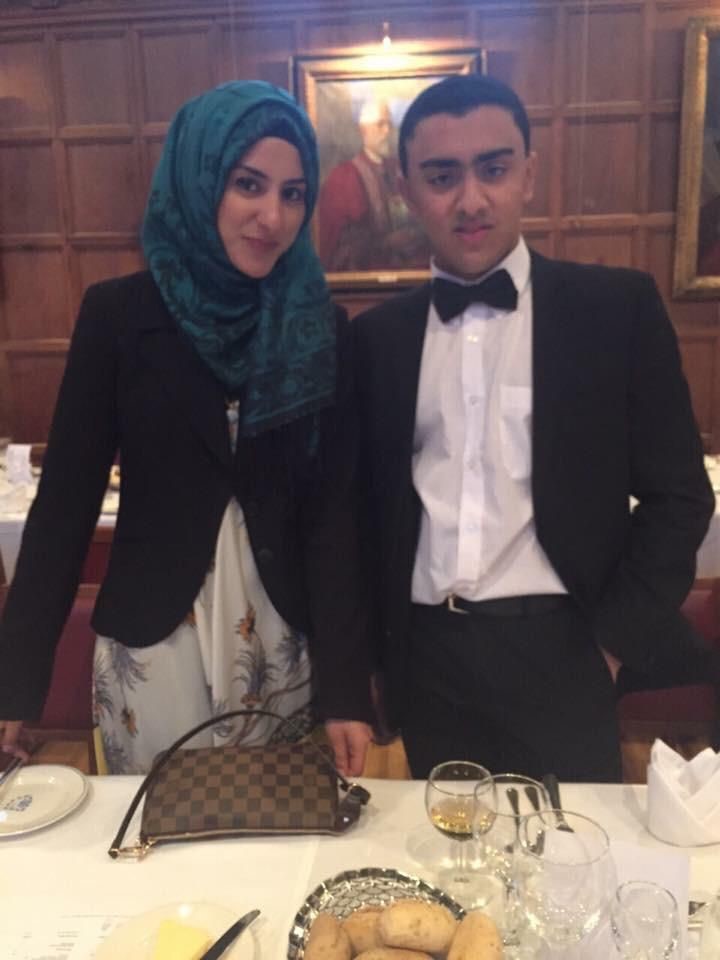 two people at a celebratory dinner in formal dress